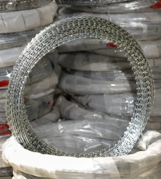 Concertina coil wire roll stored with packed concertina coil fencing materials